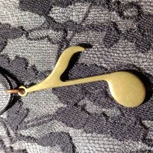 18-24" Black cotton necklace w/a brass colored music note pendant